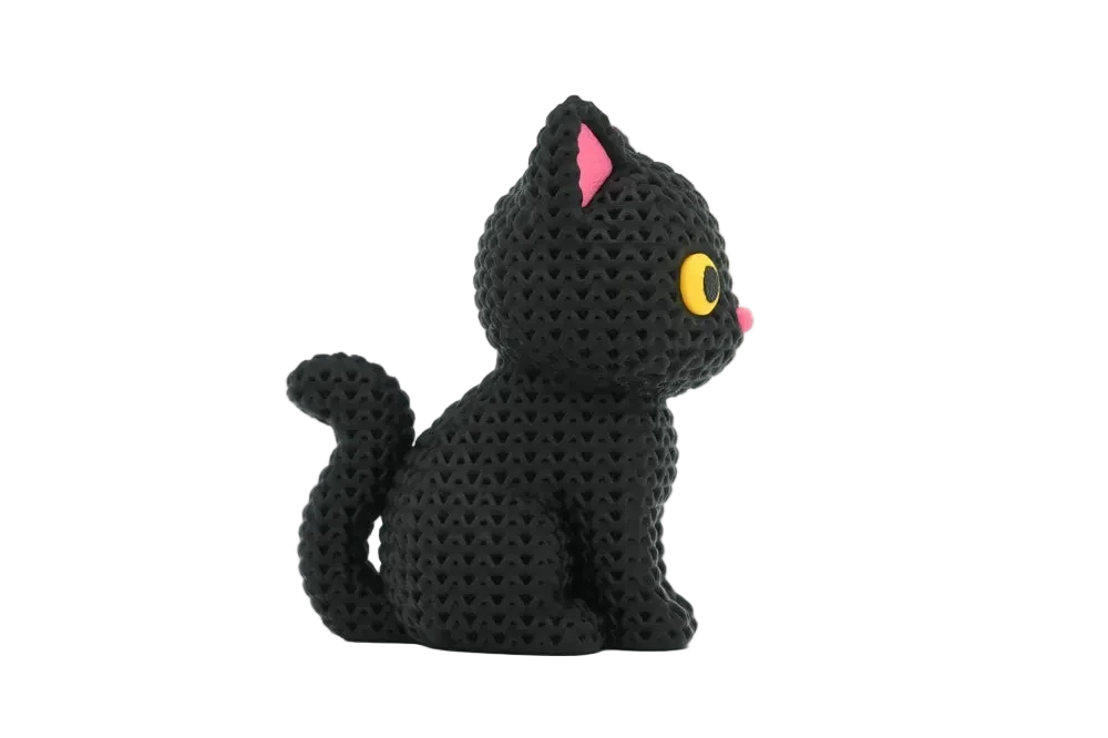 A small black knitted cat figurine with pink inner ears, a yellow eye, and a pink nose, shown on a clean white background.